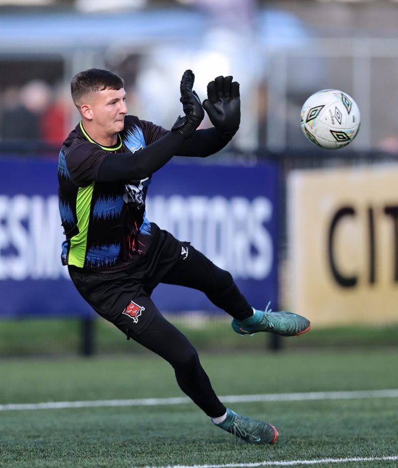 DFC v Derry City Goal keeper trying to deflect a football during a soccer game
